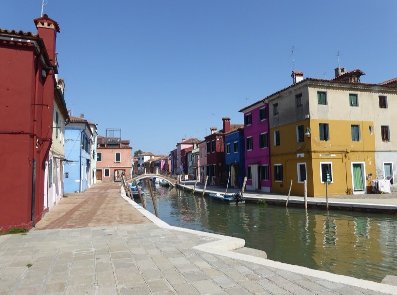 Brightly painted houses along a canal on Burano